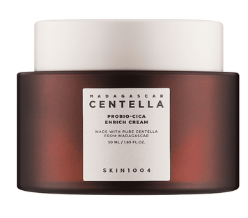 Тигель крему SKIN1004 Madagascar Centella Probio-Cica Enrich Cream 50 мл із коричнево-матовим склом і білою кришкою на світлому фоні. Живильний крем для сухої та чутливої шкіри